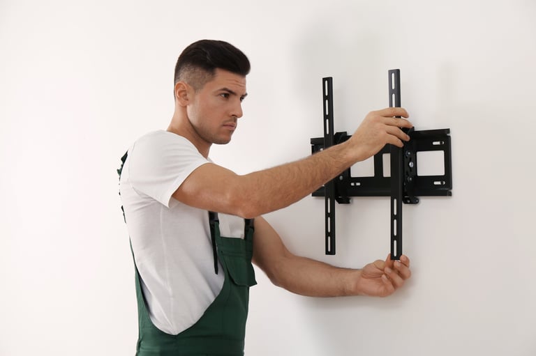 Professional technician installing TV bracket