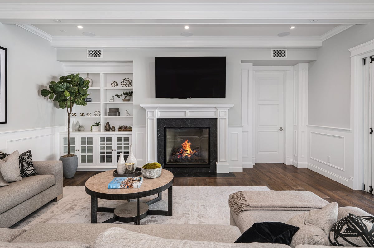 A cozy living room with a fireplace in a new construction home in Encino, California